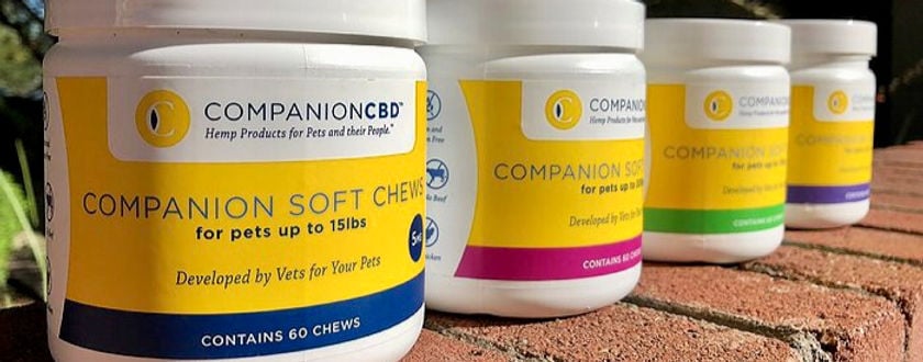 CompanionCBD soft chew product lineup on a rustic background